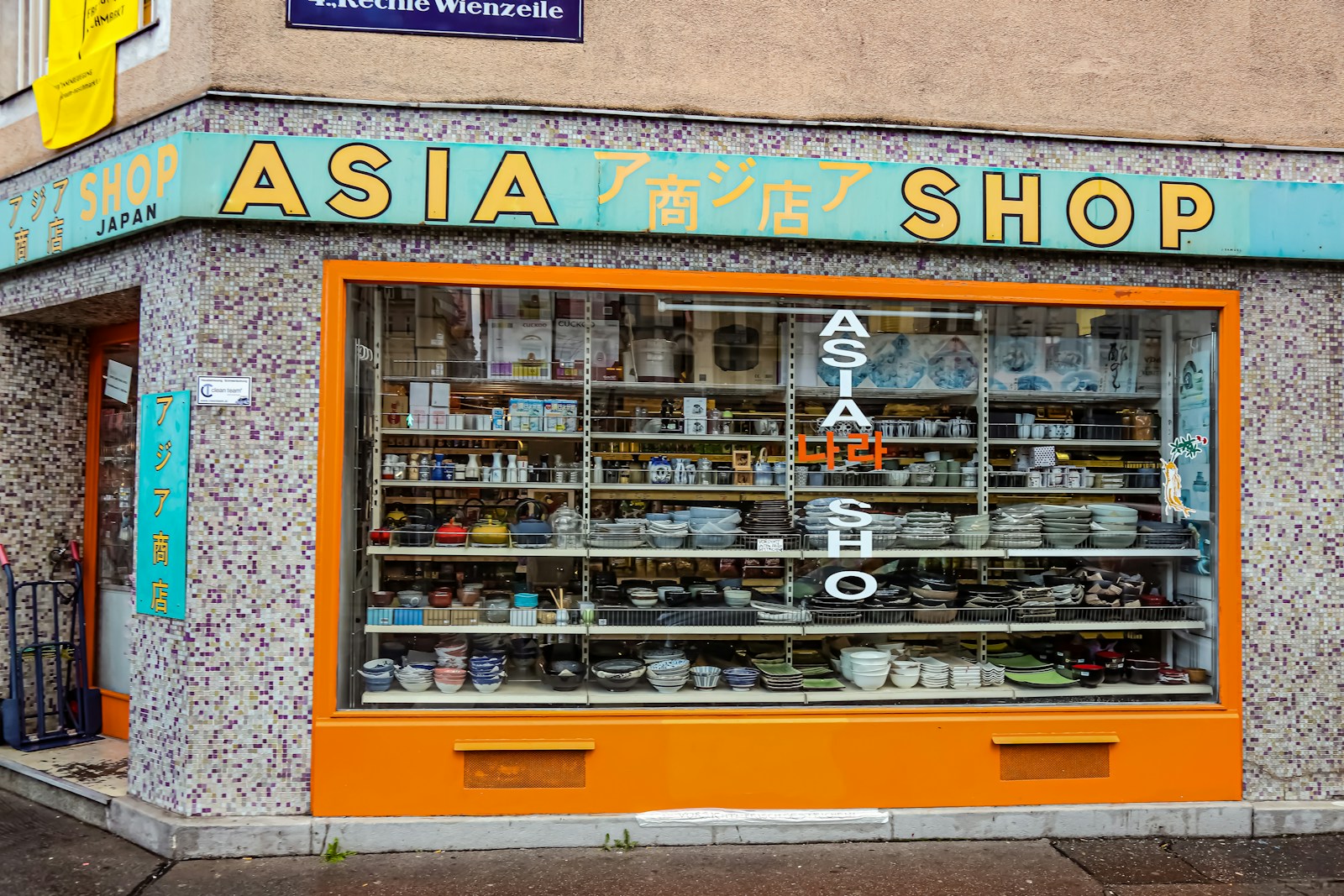 a store front with a lot of dishes on display